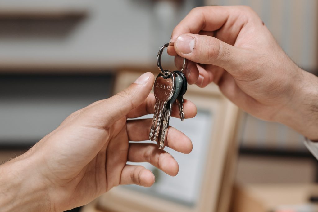 Photo of someone handing keys to a person